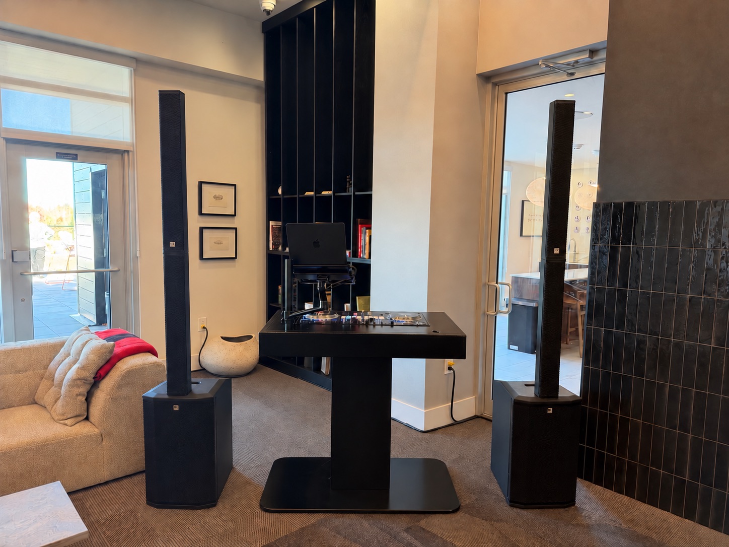Clean DJ Rich event setup with two column speakers and DJ booth